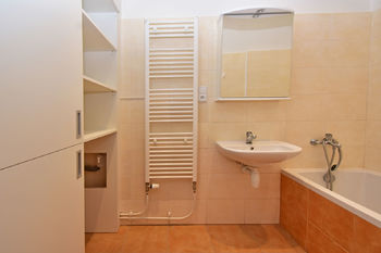 Koupelna s vanou, umyvadlem a vestavnou skříní s přívodem na pračku.   - Pronájem bytu 3+1 v osobním vlastnictví 87 m², Praha 2 - Vinohrady