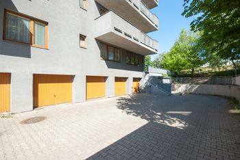 Vjezd do garáží - Prodej bytu 3+1 v osobním vlastnictví 79 m², Praha 8 - Kobylisy