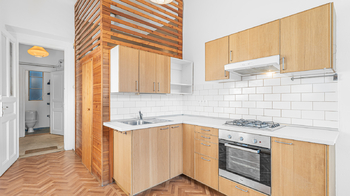 Koupelna oddělená dřevěnými deskami je součástí kuchyně - Pronájem bytu 1+1 v osobním vlastnictví 41 m², Praha 2 - Vinohrady