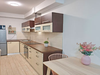 Obývací pokoj se vstupem na terasu a zahradu, jídelní a kuchyňský kout.  - Pronájem bytu 2+kk v osobním vlastnictví 52 m², Praha 9 - Hostavice